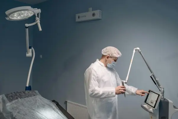 Surgeon programming laser machine touch screen with no gloves in operating room